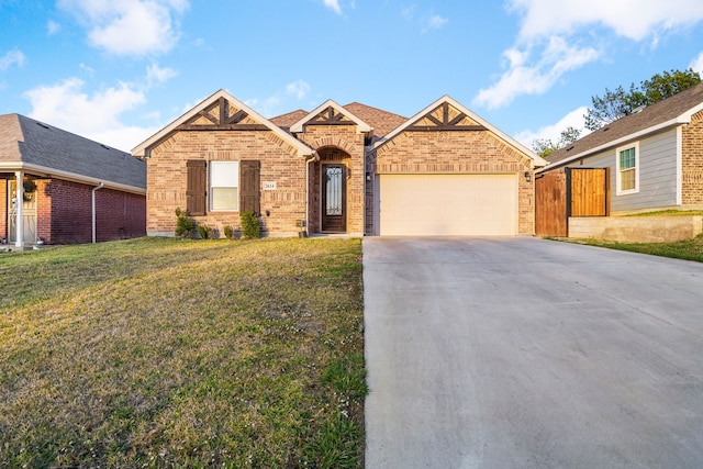 view of front of property with a garage and a front lawn