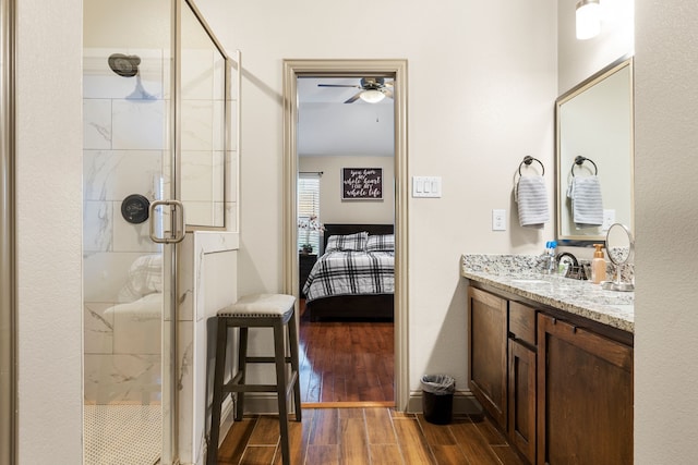 bathroom with vanity, an enclosed shower, hardwood / wood-style floors, and ceiling fan