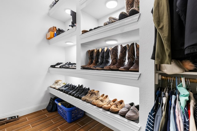 spacious closet with dark wood-type flooring