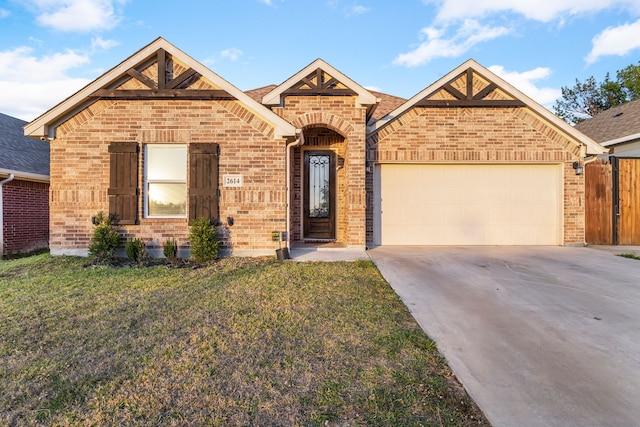 view of front facade with a front yard and a garage