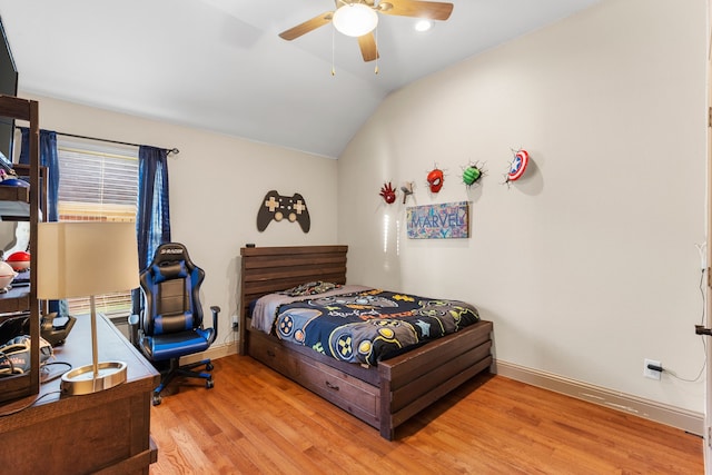 bedroom featuring lofted ceiling, light hardwood / wood-style floors, and ceiling fan