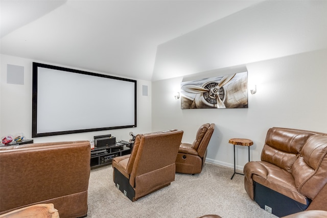 cinema room with light carpet and lofted ceiling