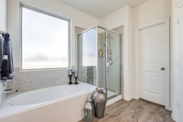 bathroom featuring hardwood / wood-style flooring and separate shower and tub