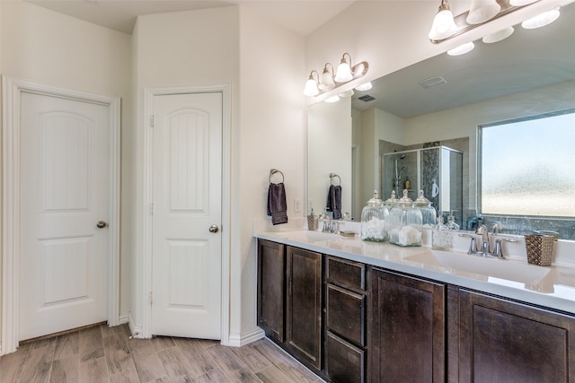 bathroom with vanity, wood-type flooring, and walk in shower