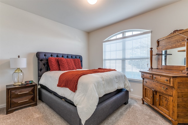 bedroom featuring light colored carpet