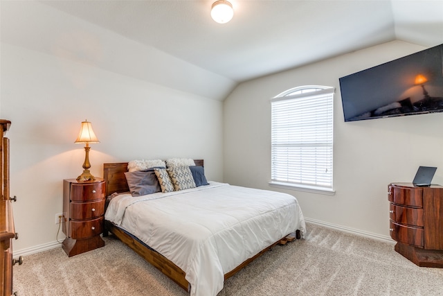 carpeted bedroom with lofted ceiling