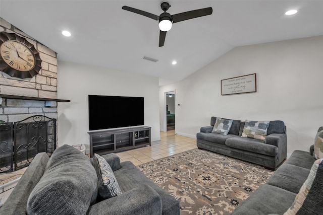 tiled living room featuring lofted ceiling, a fireplace, and ceiling fan