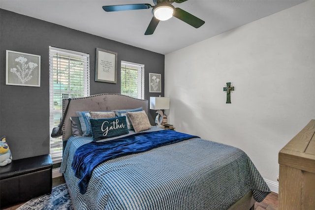 bedroom with hardwood / wood-style floors and ceiling fan