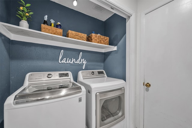 washroom featuring washer and clothes dryer