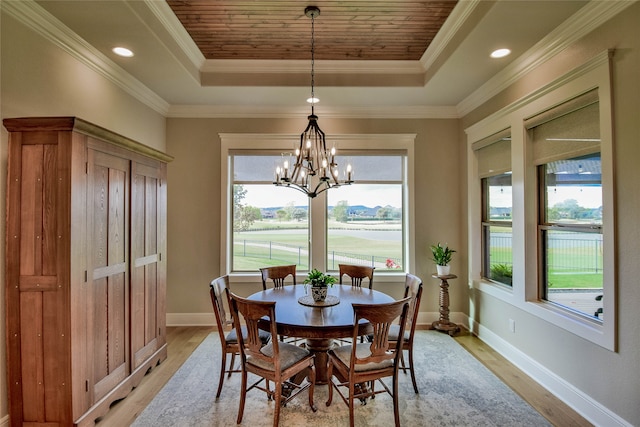 dining area featuring ornamental molding, a raised ceiling, and a wealth of natural light