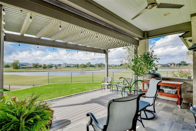 wooden deck featuring ceiling fan, a yard, a water view, and a pergola