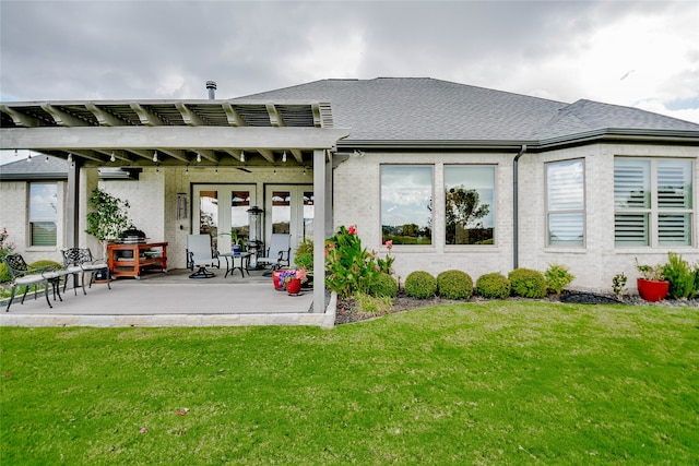 rear view of house featuring a patio area and a lawn