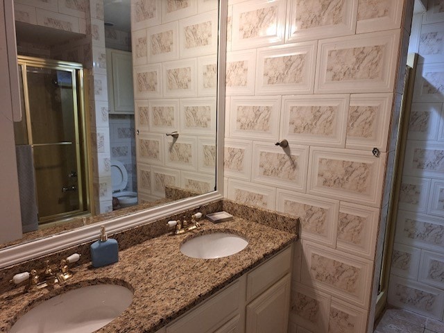 bathroom with walk in shower and vanity