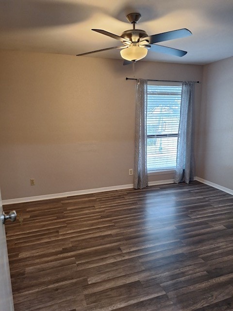 empty room featuring ceiling fan and dark hardwood / wood-style flooring