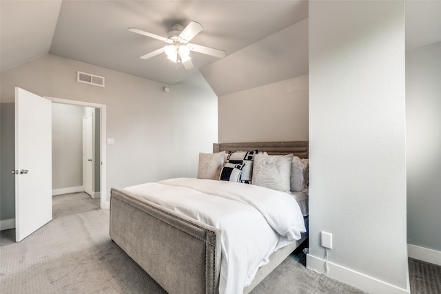 carpeted bedroom with ceiling fan and vaulted ceiling