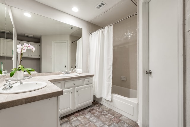 bathroom featuring vanity and shower / bath combination with curtain