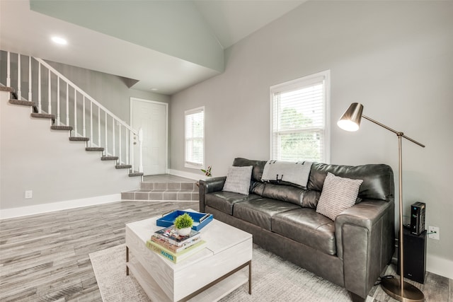 living room featuring hardwood / wood-style floors and high vaulted ceiling