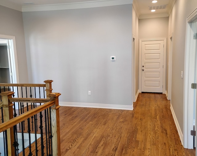 hallway featuring wood-type flooring and ornamental molding