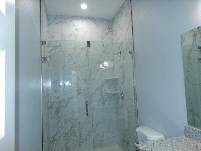 bathroom with toilet and a shower with shower door