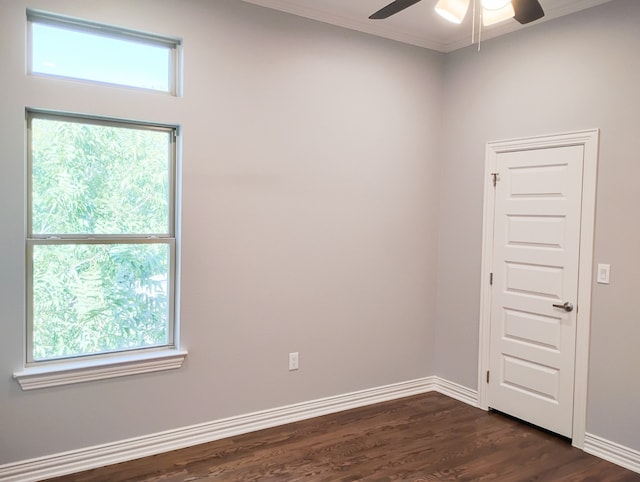 unfurnished room with dark hardwood / wood-style flooring, ceiling fan, and crown molding