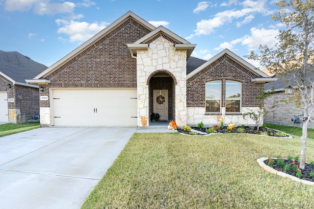 view of front of home featuring a garage and a front lawn