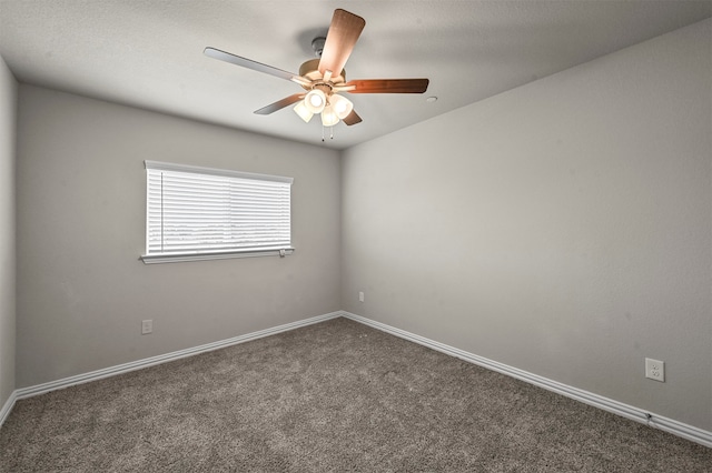 empty room featuring ceiling fan and dark carpet