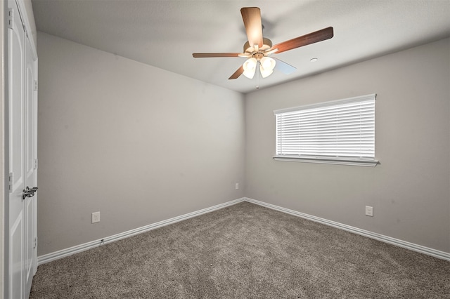 carpeted spare room with ceiling fan