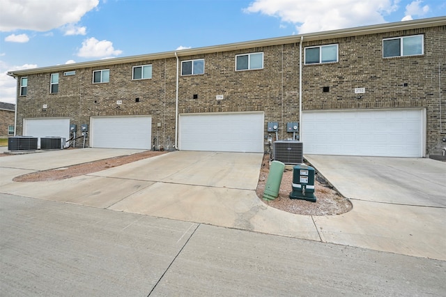 view of front of property with central AC and a garage