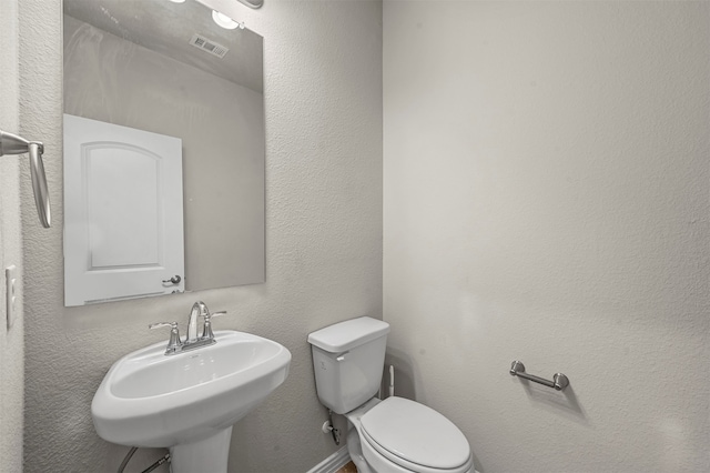 bathroom featuring toilet and sink