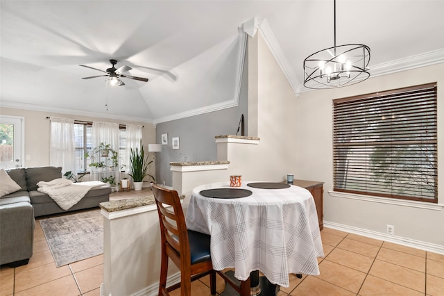 dining area with vaulted ceiling, ornamental molding, and light tile patterned flooring