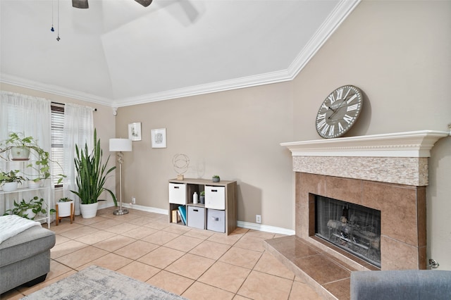 tiled living room featuring ceiling fan, ornamental molding, lofted ceiling, and a tile fireplace