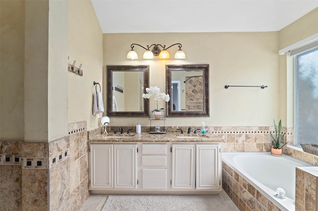 bathroom with vanity, tiled bath, and tile patterned floors