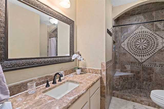 bathroom featuring vanity, curtained shower, toilet, and tile patterned flooring