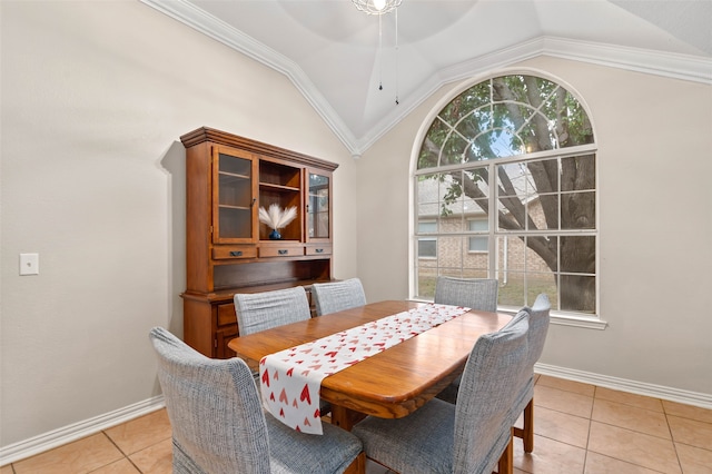 dining space with crown molding, light tile patterned flooring, lofted ceiling, and ceiling fan