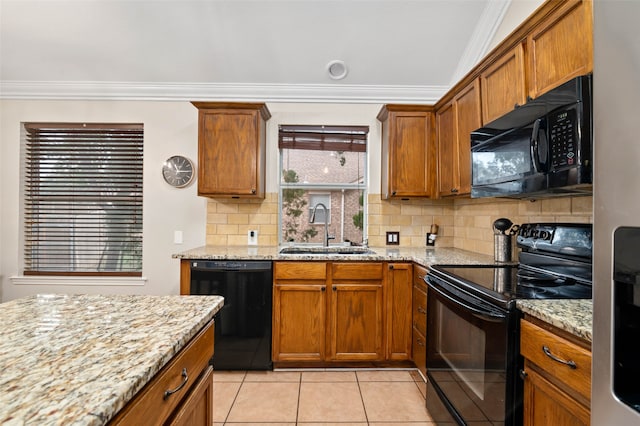 kitchen featuring crown molding, light stone countertops, black appliances, and sink