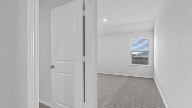 corridor with light colored carpet