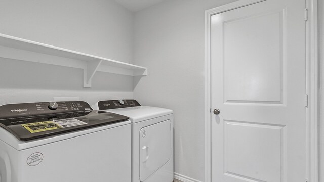 clothes washing area with washer and dryer