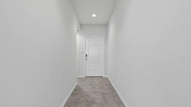 corridor with light tile patterned floors