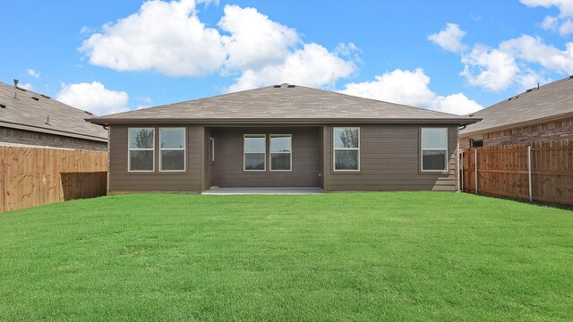 back of house featuring a yard and a patio