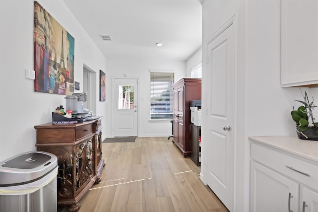 hallway with light hardwood / wood-style floors