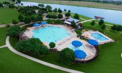 view of swimming pool featuring a patio area and a water view