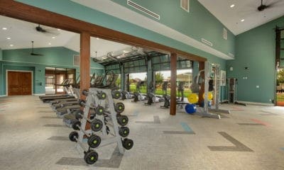 gym with high vaulted ceiling and carpet flooring