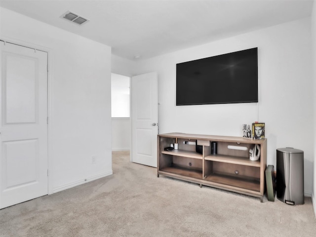 living area with visible vents, baseboards, and carpet floors