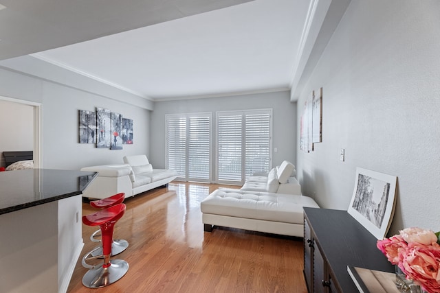 bedroom with ornamental molding and light wood-type flooring