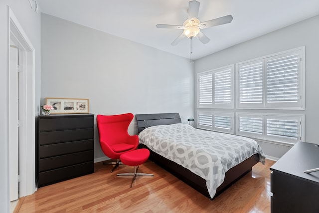 bedroom with ceiling fan and hardwood / wood-style flooring