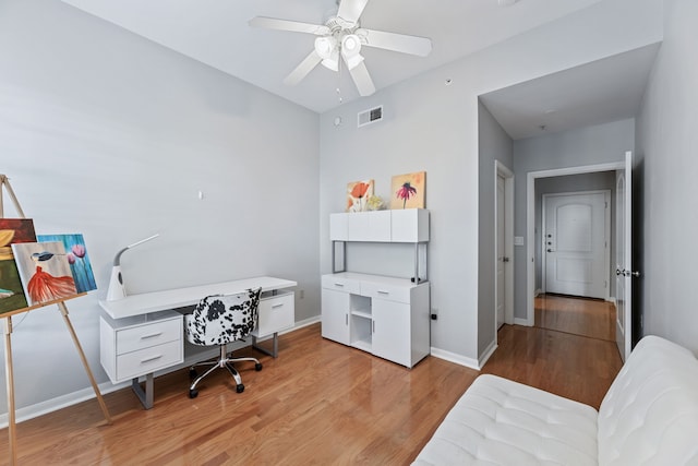 office area with light hardwood / wood-style flooring and ceiling fan