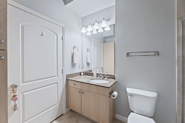 bathroom featuring vanity, toilet, and tile patterned floors