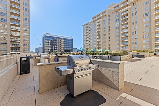 view of patio / terrace with area for grilling and a balcony