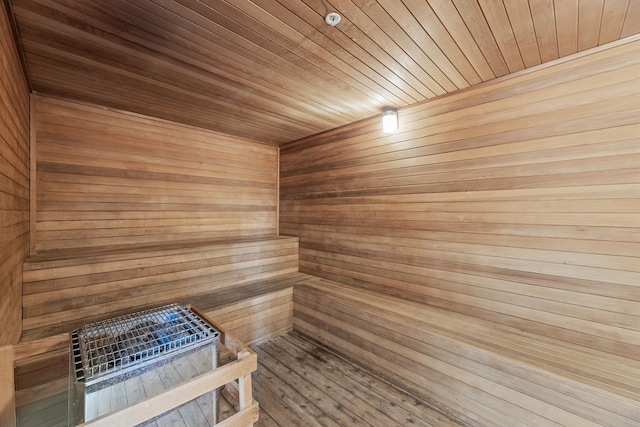 view of sauna / steam room with hardwood / wood-style floors, wood walls, and wooden ceiling