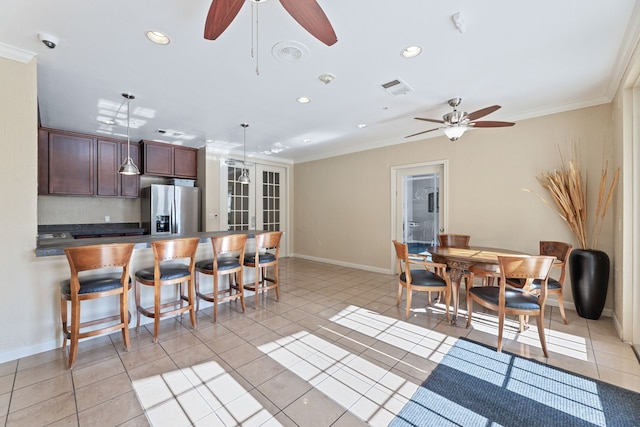 kitchen featuring light tile patterned flooring, crown molding, decorative light fixtures, and stainless steel fridge with ice dispenser